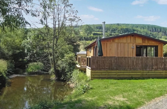 Escape to a modern riverside lodge, perfectly set by the tranquil River Clun.