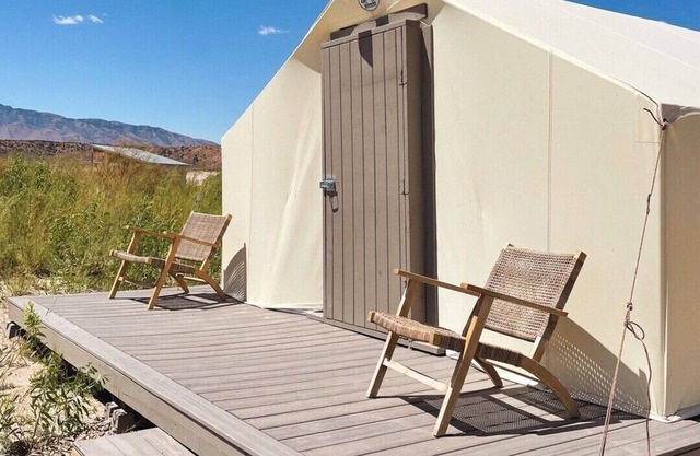 Delightful wall tent on sandy beach at waters edge