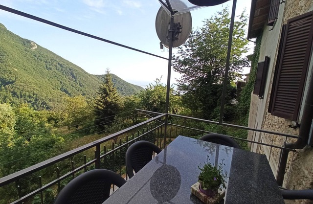 Gabberi's Breeze is located in a hamlet of houses on a hillside with a sea view