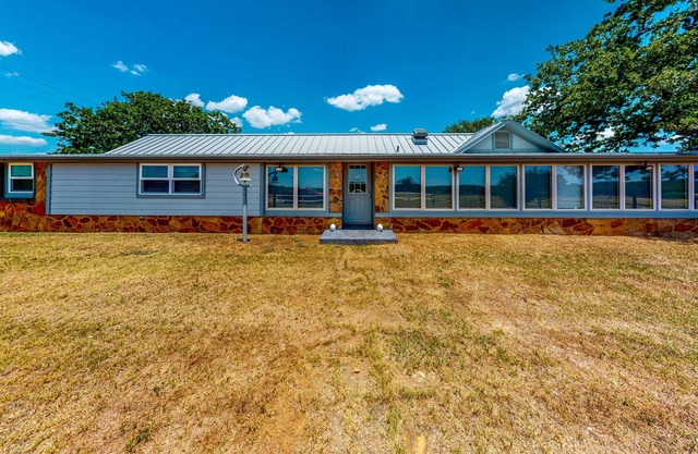 Gated Home next to Lake with Gorgeous Sunroom, Game Room & Fireplace