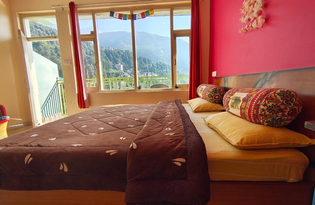 Golden View BnB Mcleodganj Room with private balcony facing mountain view.