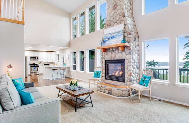 Gorgeous home with gas fireplace & enormous deck + mountain & water views