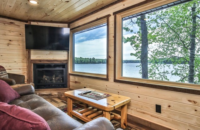 Gorgeous remodeled lakeside cabin with fireplace, personal dock, and sandy beach