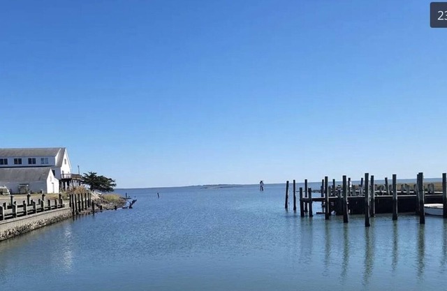 Harborside cottage (1900) steps from water’s edge with views of Barrier Islands.