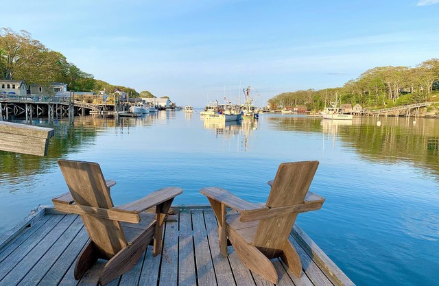 Harborside cabin with dock overlooking lobster boats