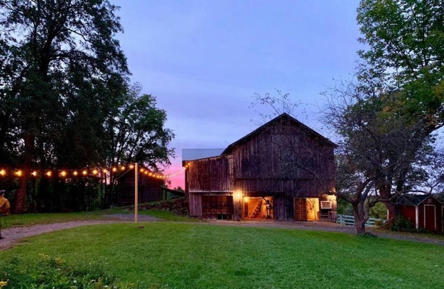 Historic Hudson Valley farmhouse with scenic barn and fire pit on a working farm