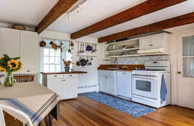 Historic stone house & barn on 10 acres with patio, fireplace, & antique charm