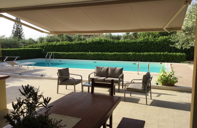 Holiday home in the countryside with a swimming pool, surrounded by greenery.