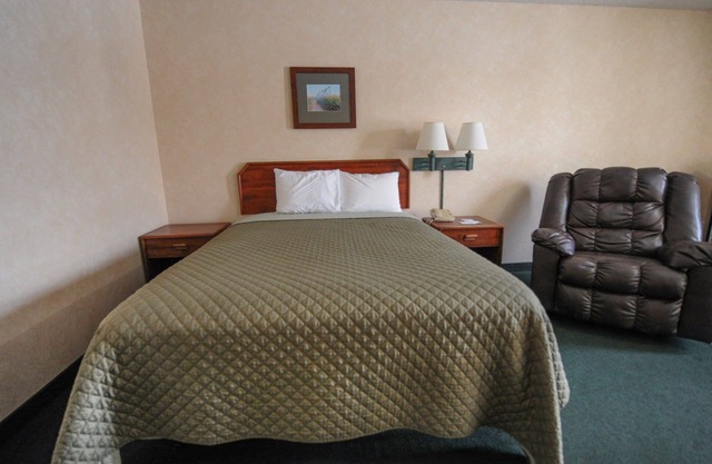 Hotel room with ONE QUEEN BED and attached, private bathroom.