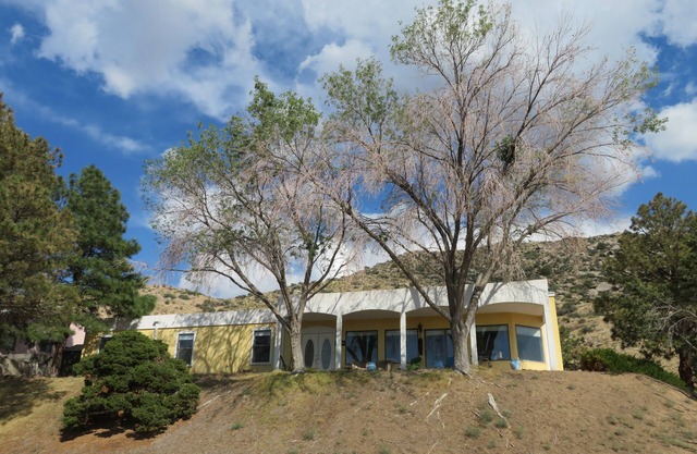 House against the Sandia mountains
