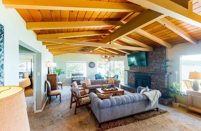 Inviting bayside dwelling with beach access, deck, waterfront views, & fireplace