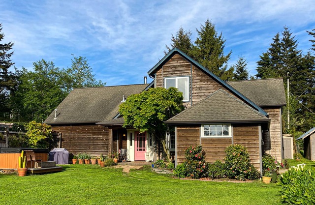 Inviting home with water view, enclosed yard, hot tub, firepit, & W/D