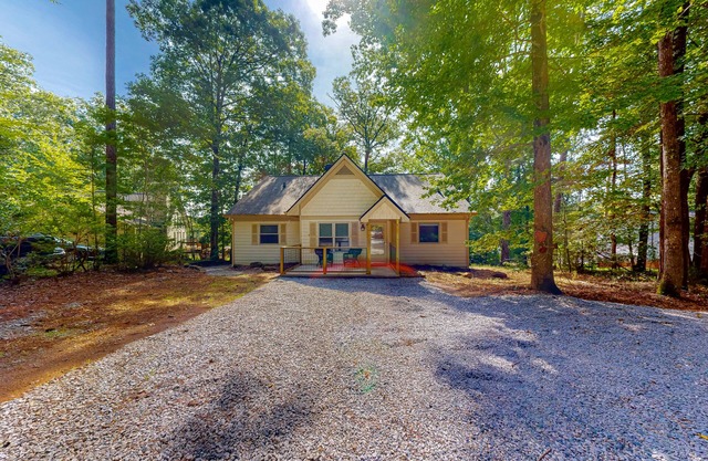 Inviting waterfront home with fireplace, dock, patio, central AC, & W/D