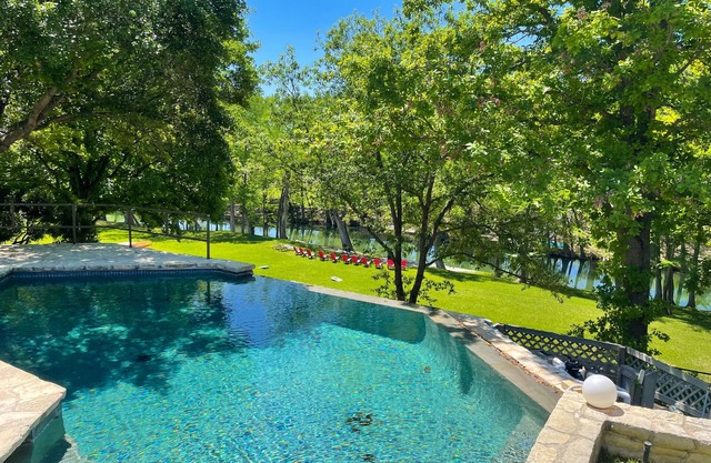 Inviting waterfront home with pool, patio, fireplace, W/D, & dog-friendly