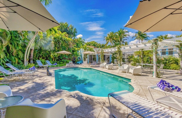 Key West Estate in West Palm Beach with 2 separate homes & stunning pool oasis.