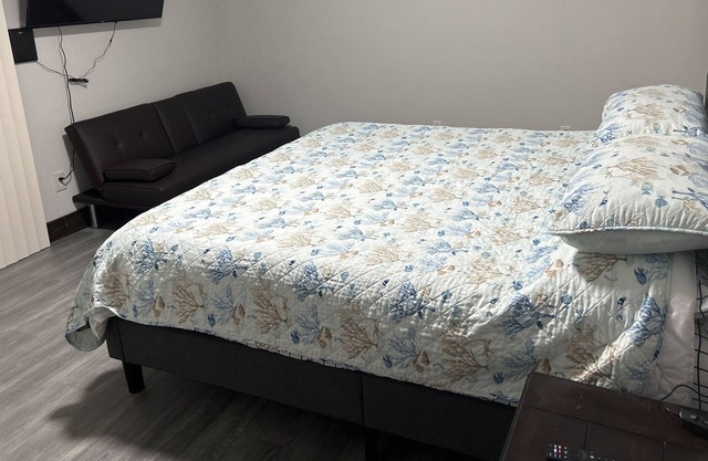 King bed room in small farmhouse with small Sofa bed.