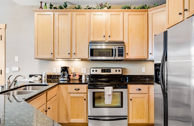 Lake-view condo with pool and hot tub access, jetted tub, firepit, and a balcony