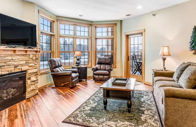 Lake view condo with 2 balconies, fireplace, pool, hot tubs, gym & sports courts