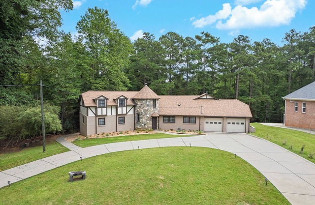Lakefront 4BR/6BA home with private dock, fire pit, smart TVs in all rooms, sunroom, BBQ grill, and fenced game yard. Includes golf cart, 2 fridges, double oven, and more. 1 mile to Aqualand Marina & Pig Tales Restaurant.