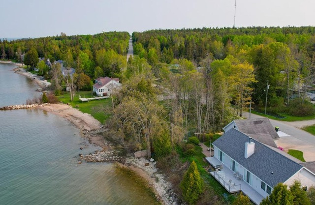 Lakefront De Tour Village Home with Deck and Fire Pit!