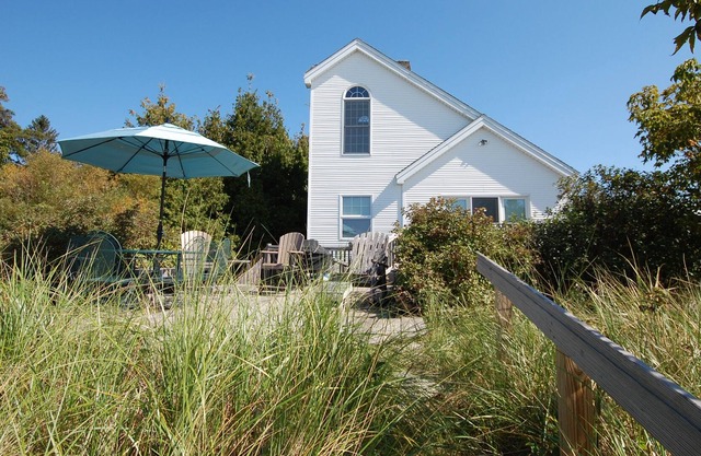 Lakefront home with a firepit, kayaks, gas grill, and deck