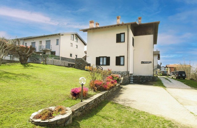 Large apartment with covered outdoor patio with table and barbecue.