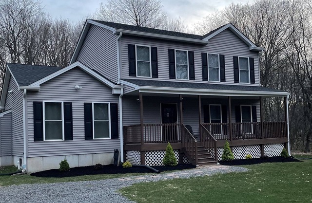 Large Pocono Mountain Getaway with private hot tub, finished basement and bar!