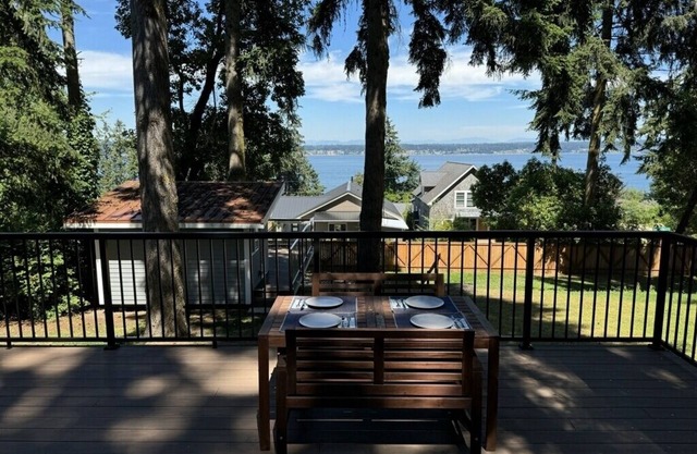 Light-filled home with Puget Sound view, great deck, fenced yard & fireplace