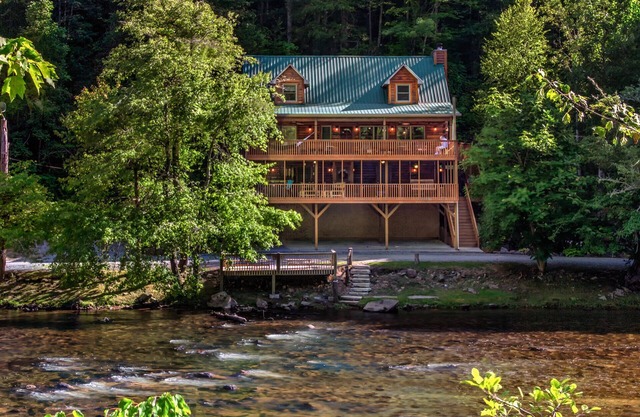 Log cabin with large decks on the Bank of the Tuckasegee River.