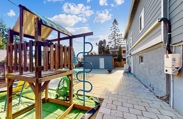 Lower-level home with spacious fenced backyard, playground, BBQ, firepit