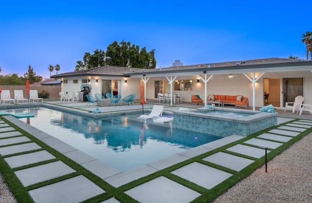 Luxurious and spacious modern ranch style home with a lap pool, spa and fire pit