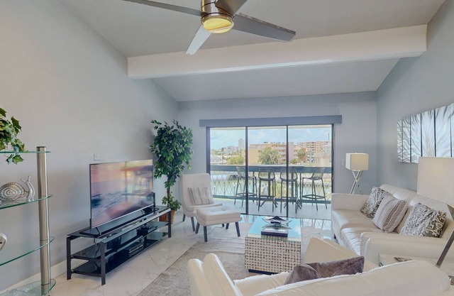 Luxurious Coastal Condo with Waterway Views, Pool, Balcony, and Steps to Treasure Island Beach.