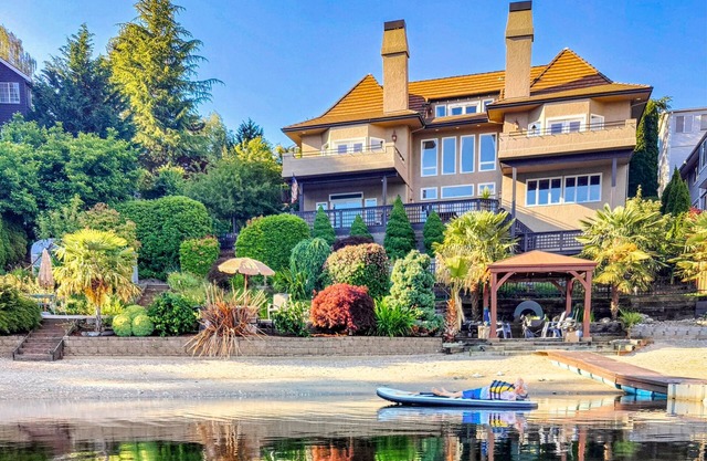 Luxury lakefront home w/ private beach, kayaks, hot tub, dock, fireplaces & gym