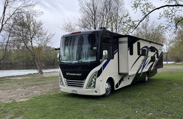 Luxury RV with Bunkbeds Stationed near a Serene River