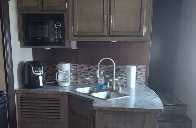 Modern 1 bedroom RV w/ futon and a fireplace - Right by the river!