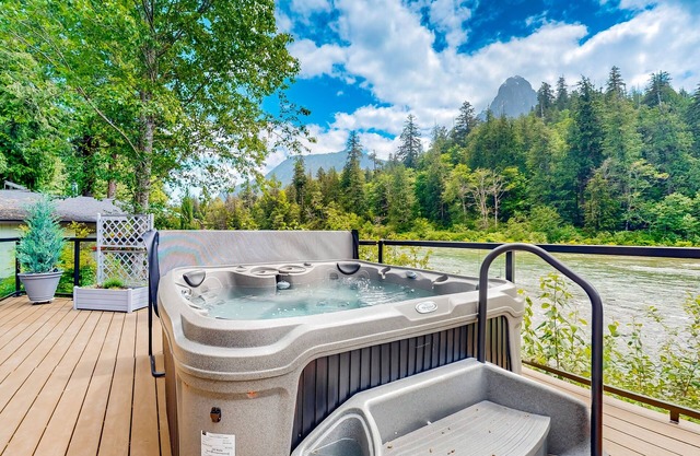 Modern riverfront home with hot tub, gas grill and patio
