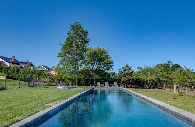 Modern-style home with a private pool, vast back lawn, several sitting...