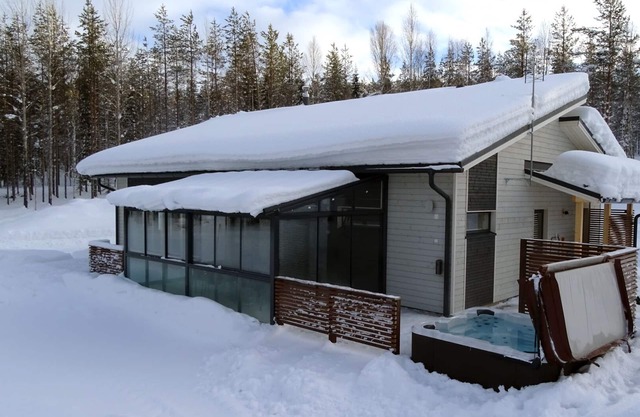 Modern Villa Lumikko with outdoor hot tub.