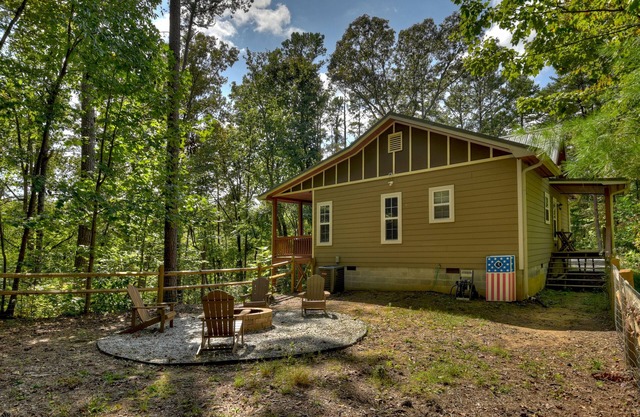 Mountain Livin' beckons with pet-friendly charm, complete with a fenced yard, soothing hot tub, crackling firepit, and reliable WiFi