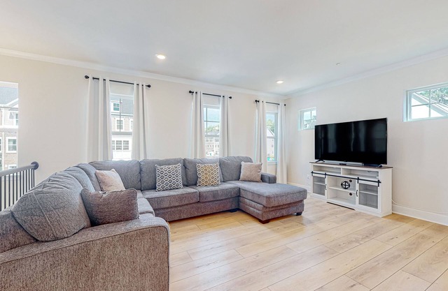 Newly built row-end townhome with water view, pool access, patio, & balcony