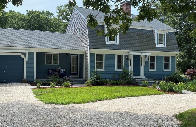 Newly listed for summer! Beautiful family home steps to largest lake on Cape Cod