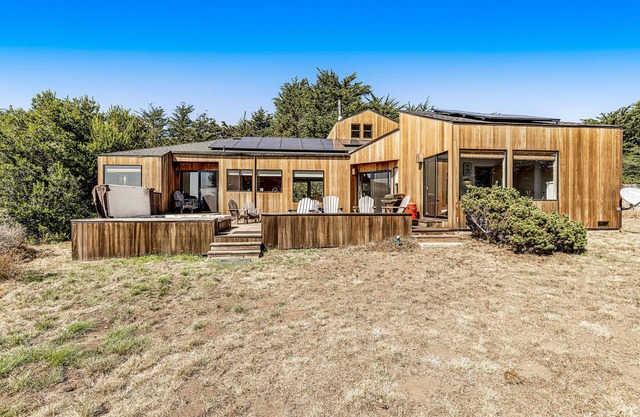 Ocean view home w/ private hot tub, pool, wood stove, and private W/D