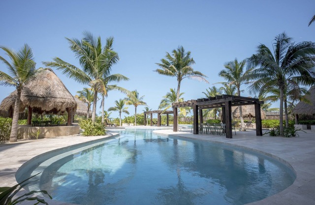 Oceanfront retreat with private balcony, outdoor pool, and stunning views