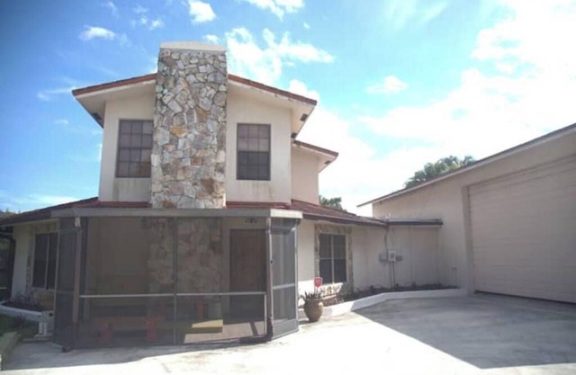 Octagonal 2-story West Palm waterfront home w/dock, boat ramp, & private parking