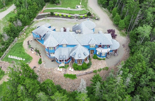 One-of-kind estate with unique & luxurious decor and wooded oceanside location.