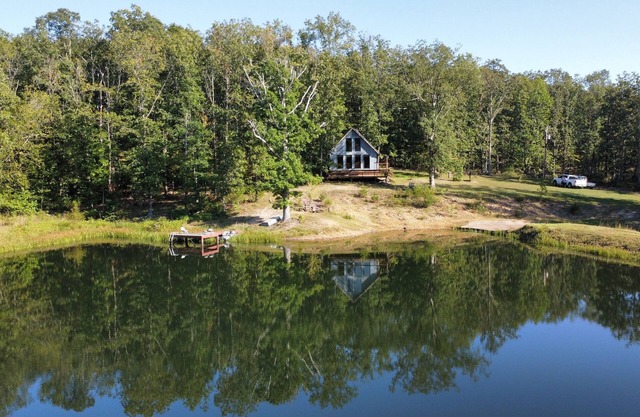 Peaceful secluded cabin nestled on 40 wooded acres overlooking 4 acre pond.