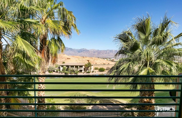 Perfectly refined home w/ large balcony, overlooking lake and palms..