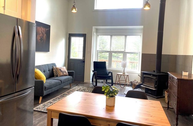 Quiet, serene accommodation with fire pit, lake view, screened-in sitting area.