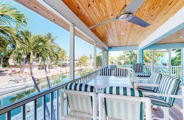Radiant waterfront retreat with remarkable views, patio, tennis court, & grill