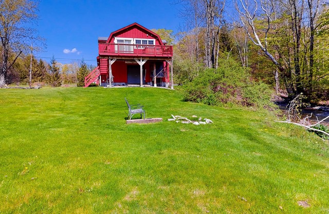 Red barn retreat with river views, hot tub, deck, firepit, & large yard